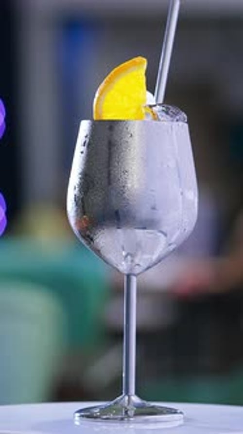 Metallic Wine Glass with Orange Slice and Ice