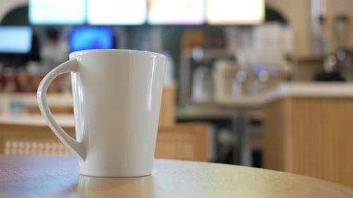 Enjoying Warm Drink in a Cozy Cafe Setting