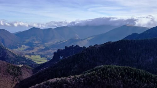 Clouds Pour Over the Mountain Ridge