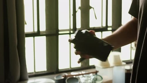 Close-Up of Hand Shaking Protein Shaker and Drinking Indoors