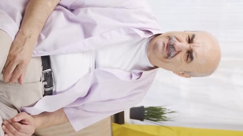 Vertical video of The old man who smells bad odor is disturbed and disgusted.