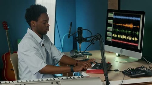 Male Songwriter Producing Music at Studio