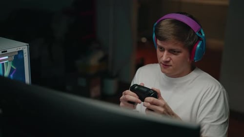 Focused man playing video game with controller