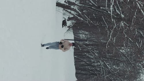 Vertical Screen Slow Motion Man Running Up the Hill in Winter Forest