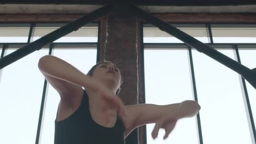 Woman Stretching Arms in Bright Urban Gym