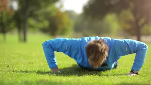 4k video footage of a man completing a set of pushups in the park