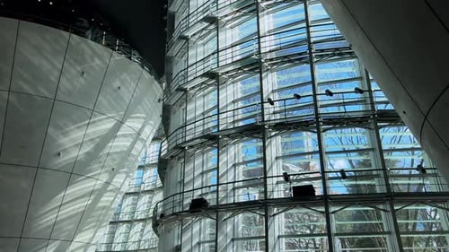 Glass facade and curved architecture at The National Art Center, Tokyo, interior view