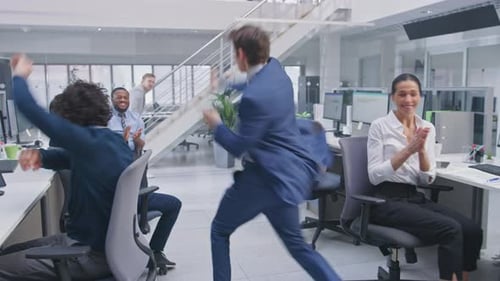 Young Happy Business Manager Wearing a Suit and Tie Dancing and Giving High Fives in the Office. Ce