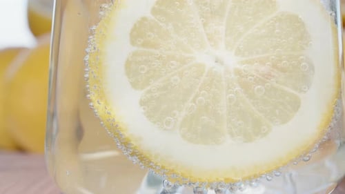 Refreshing Lemon Slice in Sparkling Water Glass