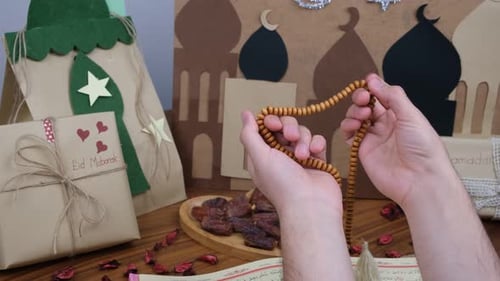 Hands Praying with Beads at Eid Celebration