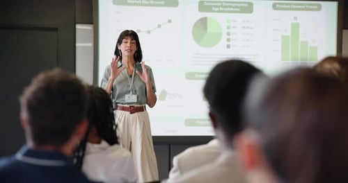 Woman Giving Business Presentation to Audience