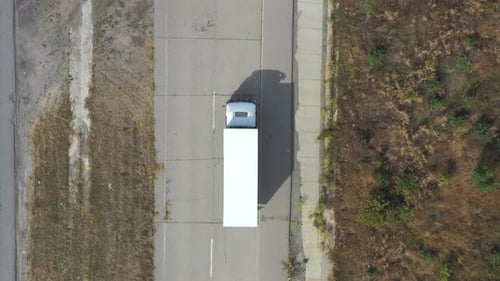 Aerial View of Truck with Trailer Driving on Straight Road and Transporting Goods