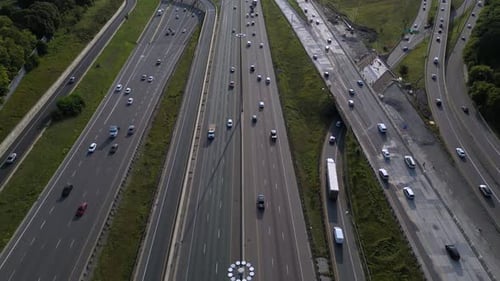 Rush hour traffic on busy highway showing vehicles driving on multiple lanes with transport trucks