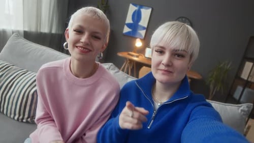 Two Friends Chatting on the Sofa at Home