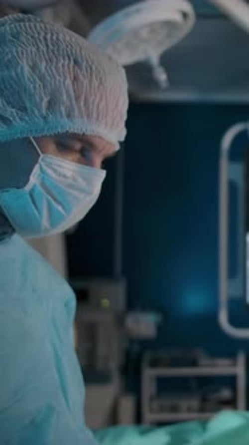 Vertical of Two Serious Doctors Look at Each Other Before Making a Decision in the Operating Room