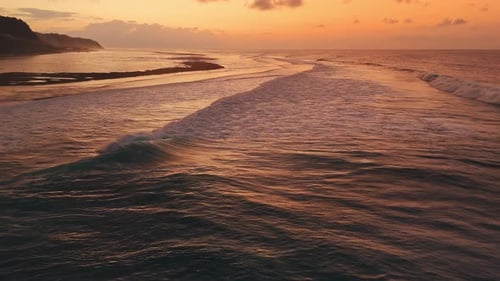 Bali Coastline with Ocean Waves on Low Tide and Sunrise Tones Drone View
