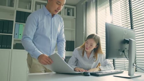 Asian businessman and Caucasian businesswoman people work in office.