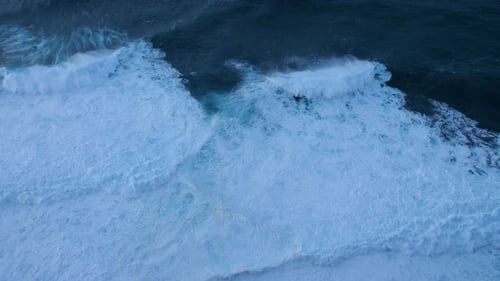 Dark ocean large, turbulent waves in madeira dark blue water contrasts with the white foam power of