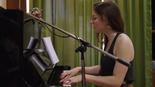Woman Plays Piano and Sings a Song