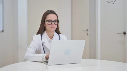 Young Doctor Smiling at Camera in Clinic
