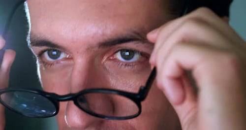 Man Puts on Glasses and Thinks