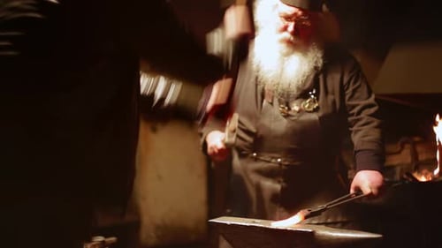 Artisan Blacksmith Skillfully Crafting Unique and Stunning Metalwork in a Historic Workshop Stock