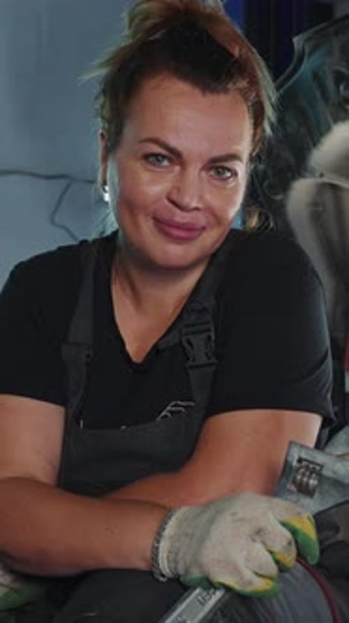Woman Working in Auto Repair Shop Showcases Her Skills and Passion