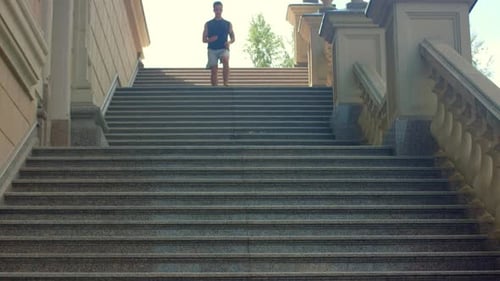 Young Man Runs Down Stairs in Outdoor Workout