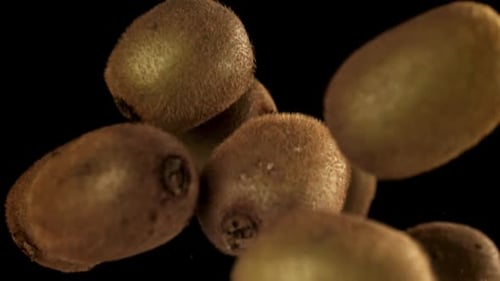 Kiwi Fruits Rotating on a Black Background, Close Up