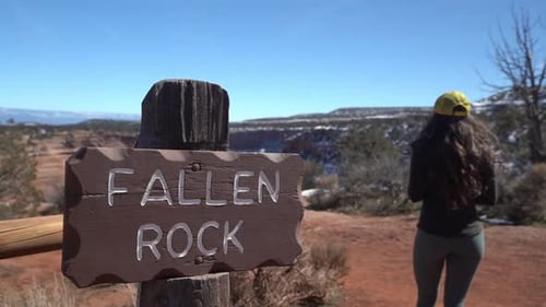 Fallen Rock Sign and Female on Lookout Point in Colorado National Monument Park USA