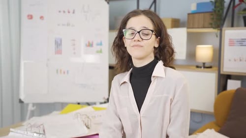 Woman Speaking in Front of White Board
