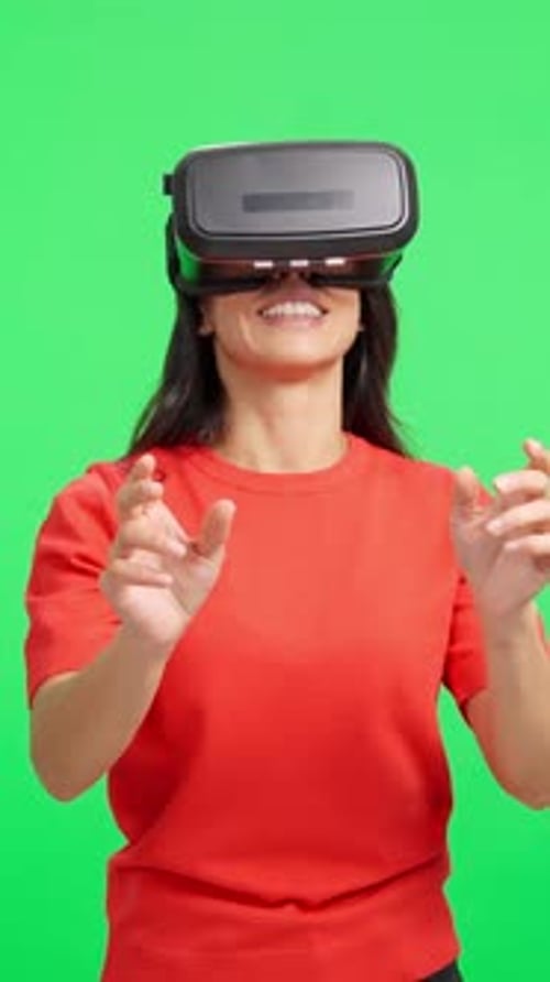 Woman Wearing Virtual Reality Headset Gesturing on Green Screen