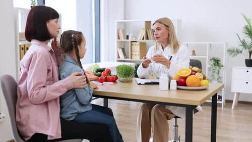 Doctor Consults with Mother and Child About Health