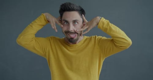 Man Making Playful Faces with Funny Expressions