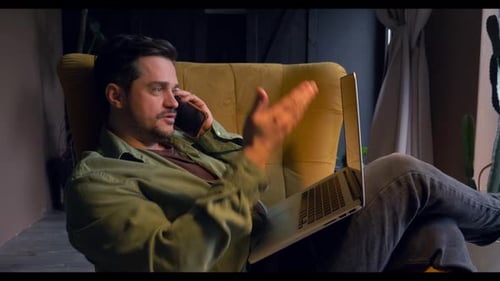 Man Relaxing in Chair with Laptop and Phone
