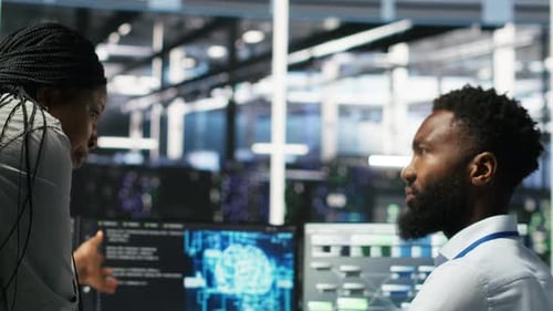 Data Center Supervisor Overseeing Work Done By Engineer Using Deep Learning