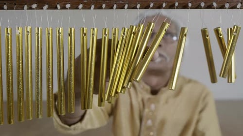 Musician Performing with Wind Chimes