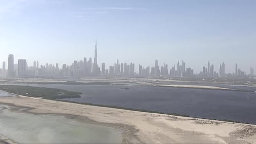 Aerial establishing shot of the Burj Khalifa and silhouette skyline in Abu Dhabi, UAE