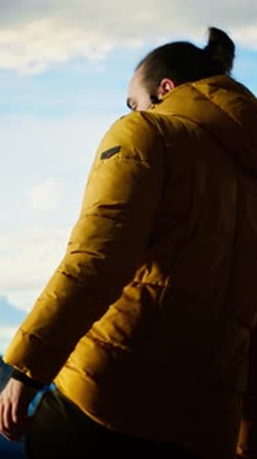 Vertical Video Determined Trekker Looks Out at the Epic Mountain Range and Sightseeing