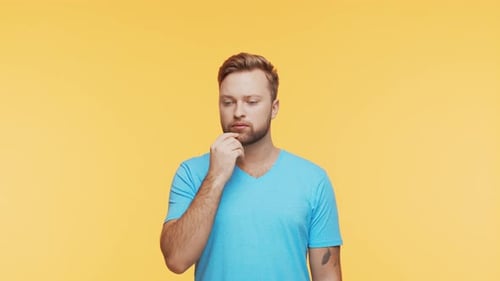 Thinking Young Man Over Vibrant Background Studio Portrait of Expressive Handsome Person