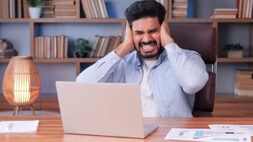 Man Distracted By External Noise Poor Sound Insulation Covers Ears with Hands