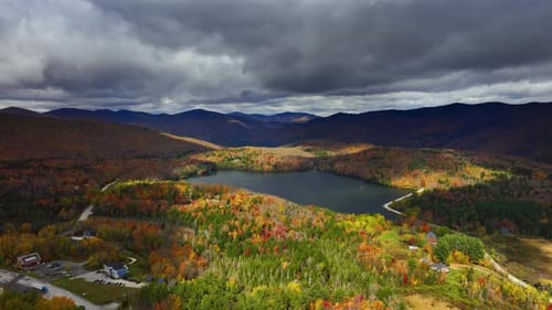 Mountain lake reflecting the grey cloudscape hanging above it. Vermont, New England, USA