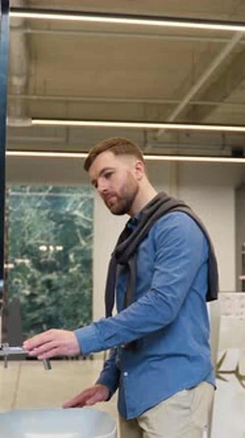 Handsome Man Choosing New Bathroom Furniture at Luxury Plumbing Shop Vertical Video