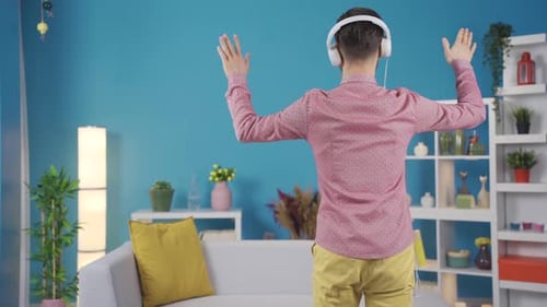 Man Happily Dancing to Music at Home