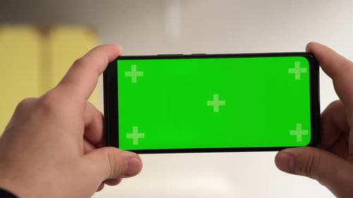 Man Hands Holding Green Screen Chroma Key Smartphone in Office Without Keying