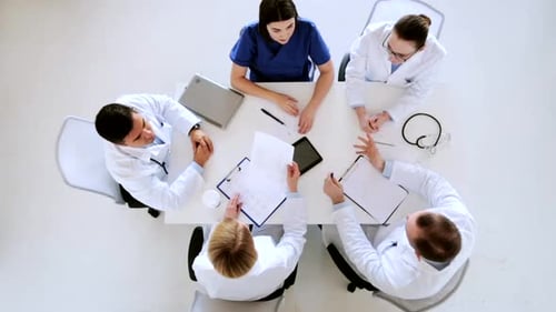Doctors celebrate teamwork with high five gesture at hospital conference