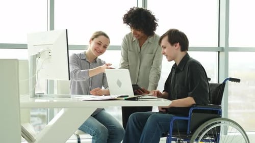 Three office workers collaborating on a project