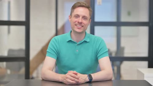 Mature Adult Man Smiling at Camera in Office