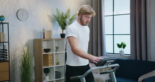 Man Running on Treadmill at Home