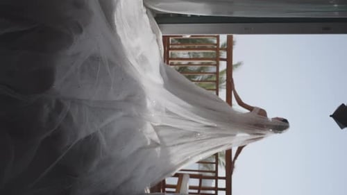 Bride with Long Veil on Patio in Tropical Setting